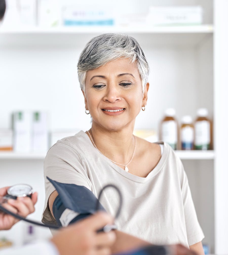 Woman checking her blood pressure at home
